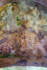 illustrations from the bible on the wall of an abandoned temple