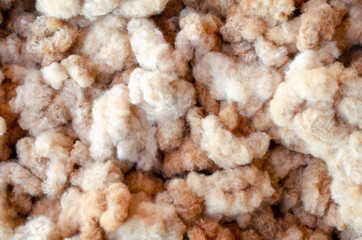 Closed up soft white and brown cotton after harvested, ready for fabric or garment production