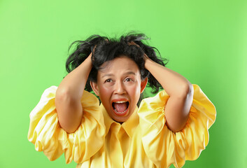 Portrait of angry crazy woman isolated on green screen background.