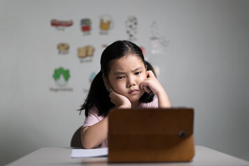 asian child student or kid girl stressed thinking and unhappy learning on computer tablet video...