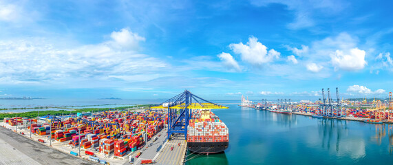 Aerial top view over international cargo ship at industrial import-export port prepare to load...