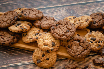 Homemade chocolate chip cookies on wooden table, snack for free time