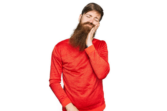 Redhead man with long beard wearing casual clothes thinking looking tired and bored with depression problems with crossed arms.