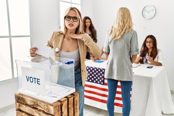 Group of young girls voting at democracy referendum cutting throat with hand as knife, threaten aggression with furious violence
