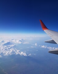 Airplane wing in the blue sky