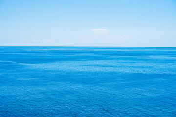 Fototapeta na wymiar Beautiful colorful seascape. Blue water and blue sky at sunny day