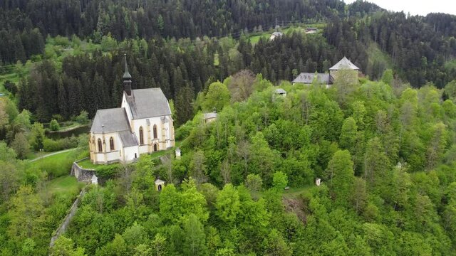 Old Church in a Forest in Austria Aerial (Murau, Styria- Leonhardkirche, Leonharditeich, and Burg Gr&uuml;nfels