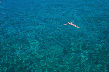 Aerial view of swimming beautiful woman in Blue Lagoon. Cyprus