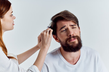 bearded man with hairdresser fashionable hairstyle close up