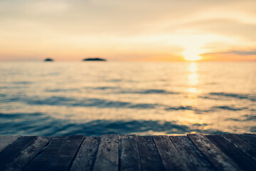 Naklejka na ściany i meble tropical sea summer background concept plank floor on ocean blur background romantic tone style sunset time