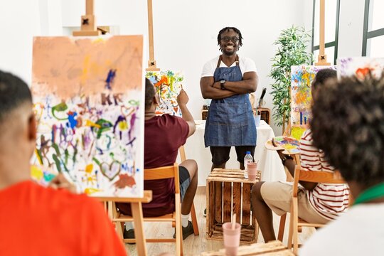 Group of young african american artist students drawing in paint class at art studio.