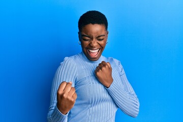 Young african american woman wearing casual clothes celebrating surprised and amazed for success...