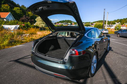 Nøtterøy, Norway - august 22, 2021 green Tesla model S P85+ is an electric car with Scandinavian port in the background.