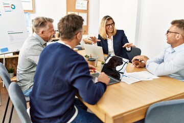 Group of middle age business workers working at the office.