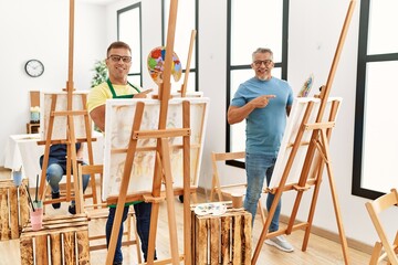 Group of middle age people artist at art studio smiling happy pointing with hand and finger