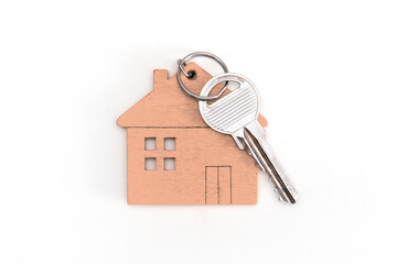 mini house figure with keys on isolated white background