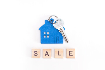 mini house figure with keys on isolated white background
