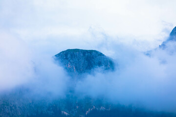 Zugspitze mountain massif disappearing in fog and clouds with dramatic sky. Copy space. Template...