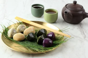 Foto op Plexiglas Traditional Chuseok Day Food, Korean Half Moon Shaped Rice Cake or Songpyeon. Made from Korean Rice Flour with Sesame Seed or Chopped Nuts, Honey, or Red Bean Paste © Ika Rahma