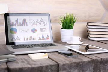 PC laptop, tablet and phone on wooden table