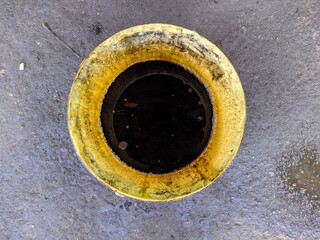 old dirty bucket with used engine oil in the garage.