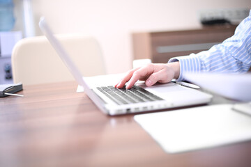 Male hands typing on laptop computer keyboard, businessman seated in cafe working with computer, businesspeople using modern devises, crop of rich businessman in suit working with laptop computer