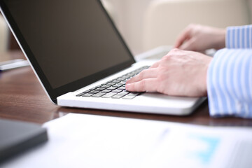Image of one young businessmen using touchpad at meeting