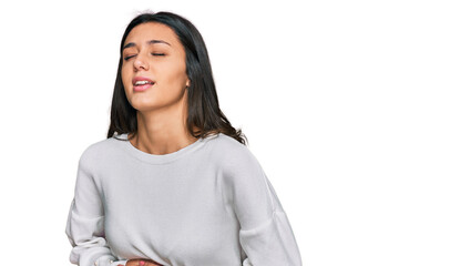 Young hispanic girl wearing casual clothes with hand on stomach because nausea, painful disease feeling unwell. ache concept.