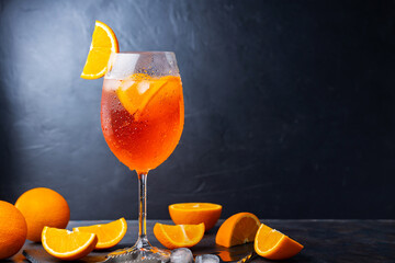 Aperol spritz cocktail and bar accessories. Italian aperol spritz cocktail and a sliced orange on a...