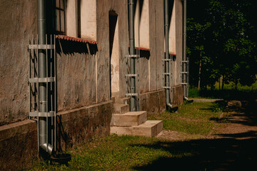 old medieval church wall with relatively new frest water drain pipes, sunlight in evening,...
