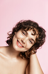 Teen skin care and cosmetology concept. Vertical shot of natural young woman with curly hair and...