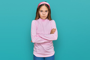 Beautiful brunette little girl wearing casual turtleneck sweater skeptic and nervous, disapproving...