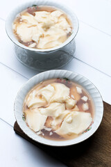 Tahwa or Wedang Tahu or Kembang Tahu, Indonesian Traditional Dessert made from Gingger and Palm Sugar Syrup with Beancurd Made from Soy Bean Milk. Serve on Bowl, Top View with Copy Space for Text