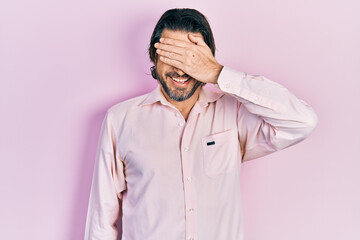 Fototapeta premium Middle age caucasian man wearing casual clothes smiling and laughing with hand on face covering eyes for surprise. blind concept.