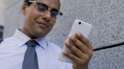 Positive biracial man doing shopping online, happy with discounts and delivery