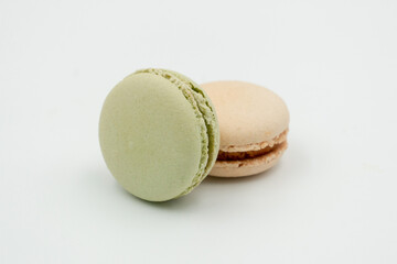 Multiple flavor Cake macaron or macaroon on turquoise macros on a white background.