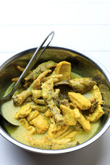 Top View Opor Ceker  Ayam Kampung with Tofu on a Bowl. Opor is Yellow Curry typically from Melayu, Indonesia, or Malaysia Cuisine. Copy Space for Text