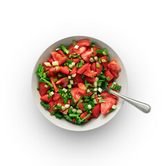 a simple salad of fresh tomatoes and green onions, in a gray cup, a close-up view from above. isolate on a white background. there is a spoon in the salad. healthy natural vegan food