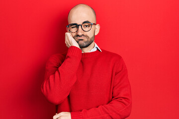 Young bald man wearing casual clothes and glasses thinking looking tired and bored with depression...