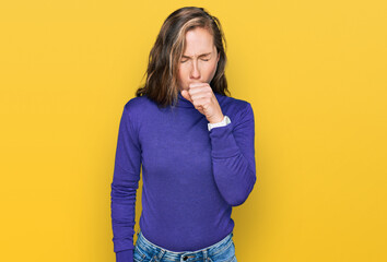 Young blonde woman wearing casual clothes feeling unwell and coughing as symptom for cold or...
