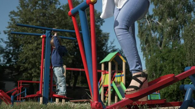 Young Pretty Woman Doing Physical Exercise Fitness on Playground. Beautiful Female Body Workout. Morning Spring Sunny Day. 2x Slow motion 60fps 4K