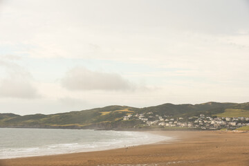 Beach view across the sand with sea shore and seaside town