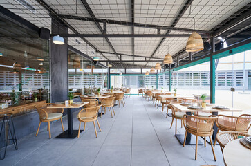 empty terrace of a rustic restaurant with wooden furniture
