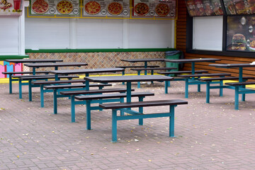 In the early morning tables and chairs without customers in a street cafe.