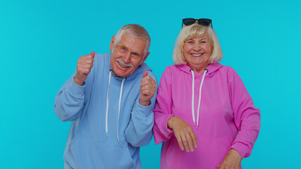 Elderly gray-haired stylish grandfather grandmother laughing out loud after hearing ridiculous...