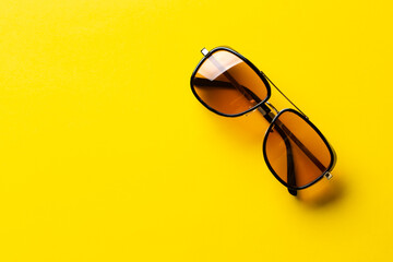Sunglasses on a yellow background. UV protection.