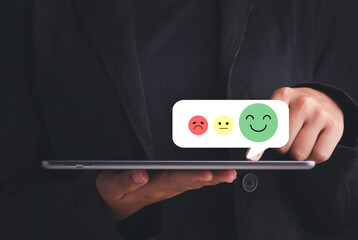 Satisfaction survey and customer service concept. Hand touching satisfaction and give scores.Give very satisfied rating with smiley face icon.