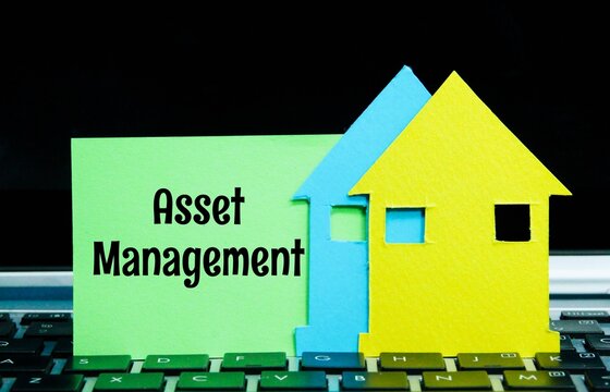 laptop keyboards, paper houses, colored paper with the word Asset Management