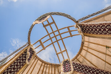 Shanyrak is a wooden crown of a yurt. The yurt is a portable, curved residential building...