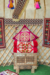 The interior of the yurt. Asian national pillows and carpets